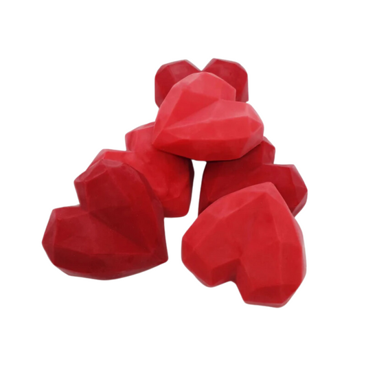 A red heart shaped wax melt (Sandalwood scent)